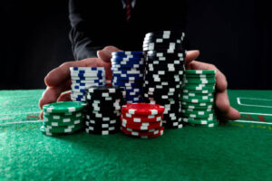 Businessman hands pushing gambling chips.